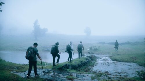Five Hikers Crossing a Misty Stream in the Wild Nature Desktop Wallpaper