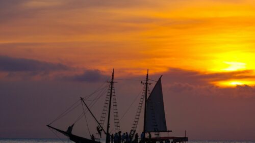 Silhouette of a Pirate Ship at Golden Sunset 4K Desktop Wallpaper