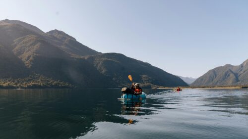 Packrafting in Serene New Zealand Lake Mountains 4K Wallpaper