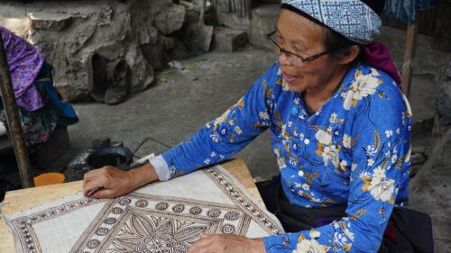 Elderly Hmong Artisan Creating Traditional Batik Art Desktop Wallpaper