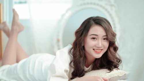 Beautiful Asian Woman Smiling on Bed Aesthetic 4K Wallpaper