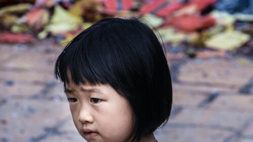 Portrait of a Thoughtful Asian Girl Close-up 4K Wallpaper