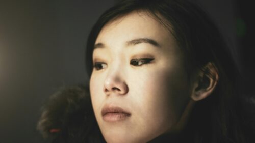 Pensive Asian Woman with Eyeliner Close Up 4K Desktop Wallpaper