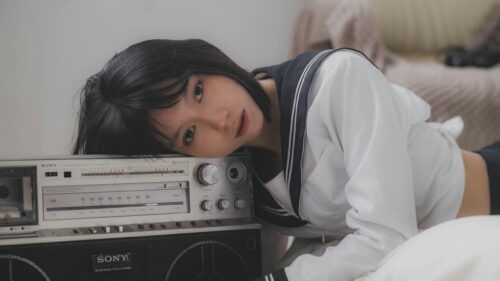 Young Asian Girl Resting on Vintage Sony Radio Desktop Wallpaper