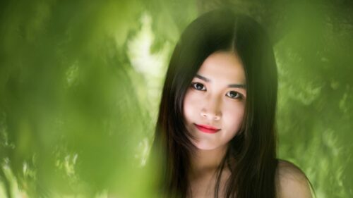Portrait of a Beautiful Asian Girl in Lush Green Nature 4K Wallpaper