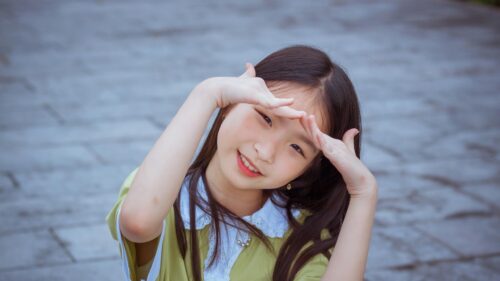 Cute Smiling Asian Girl Posing with Hands Near Face 4K Desktop Wallpaper