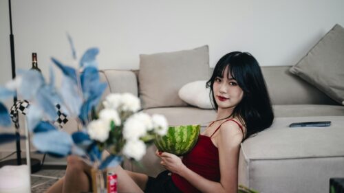 Beautiful Asian Girl Holding Watermelon in Living Room 4K Wallpaper