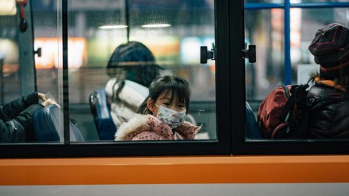 Sad Young Girl Wearing Face Mask on City Bus Desktop Wallpaper
