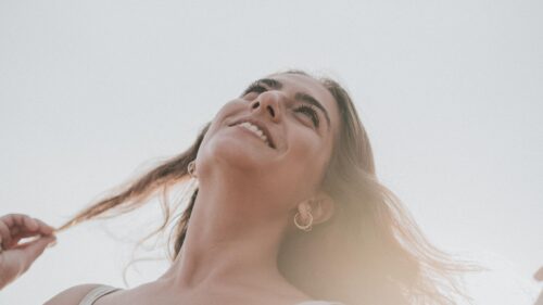 Stunning Young Woman Smiling Looking Up at the Sky 4K Wallpaper