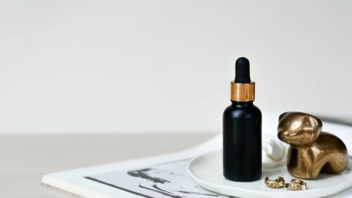 Minimalist Black Skincare Serum Bottle Aesthetic Desktop Wallpaper