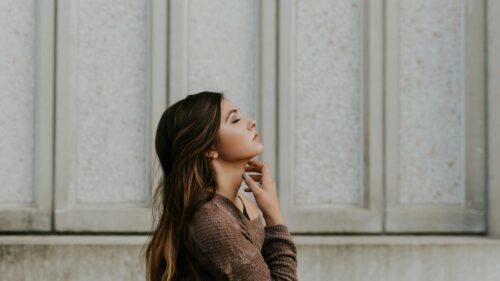 Serene Woman Portrait in Brown Sweater PC Desktop Wallpaper