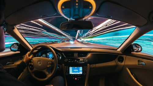 First Person Driving Through Neon City Lights 4K Wallpaper
