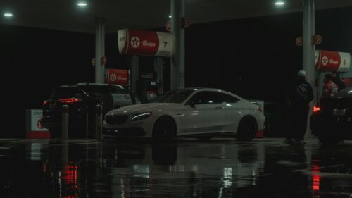 White Mercedes-Benz AMG Coupe at Rainy Texaco Gas Station 4K Wallpaper
