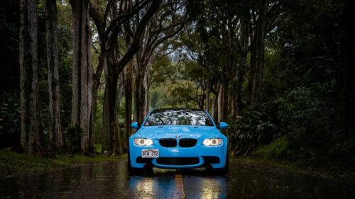 Bright Blue BMW E92 M3 Driving Through Rainy Forest Road 4K Wallpaper