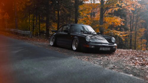 Stanced Black Porsche 911 on Autumn Forest Road Desktop Wallpaper