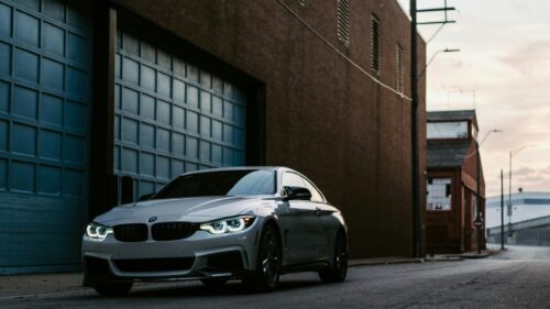 Sleek Silver BMW 4 Series Coupe Parked in Industrial Alleyway 4K Wallpaper
