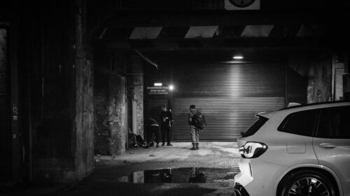 Gritty Urban Night Scene with Figures in Shadow 4K Desktop Wallpaper