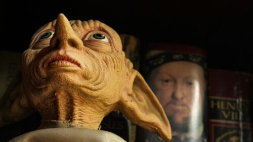 Dobby the House Elf Close-up with Historical Book Background 4K Wallpaper