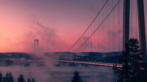 Misty High Coast Bridge at Sunset 4K Desktop Wallpaper