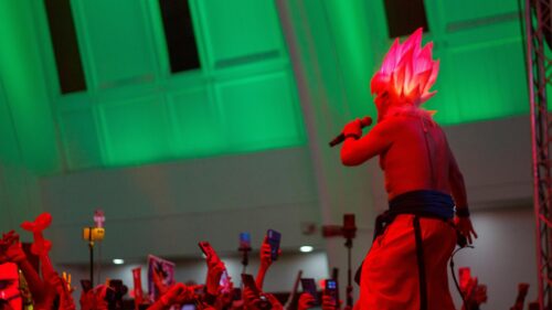 Anime Cosplay Performer with Glowing Spiky Hair 4K Wallpaper