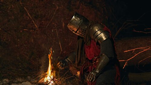 Lonely Medieval Knight Warming by Campfire 4K Desktop Wallpaper
