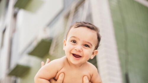 Cute Smiling Baby Flying High in the Air Desktop Wallpaper
