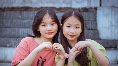 Two Cute Asian Girls Making Heart Shape Hands Desktop Wallpaper