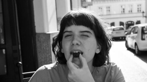Candid Portrait of a Young Woman Eating a Cookie Desktop Wallpaper