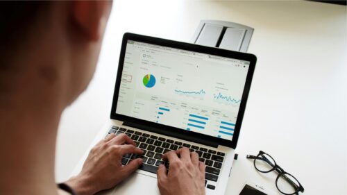 Professional Working on Data Analytics Laptop Desktop Wallpaper