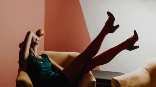 Elegant Woman Relaxing with Orange 4K Desktop Wallpaper