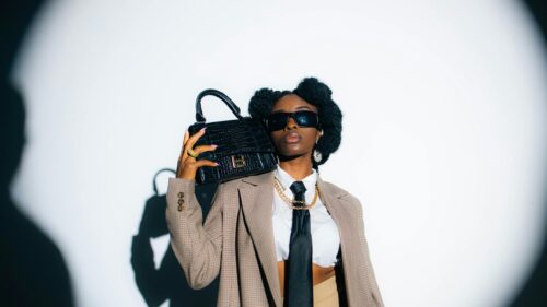 Chic Fashionable Woman in Blazer with Designer Handbag 4K Wallpaper