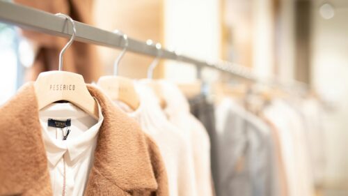 Elegant Boutique Clothing Rack with Cozy Winter Coats Desktop Wallpaper