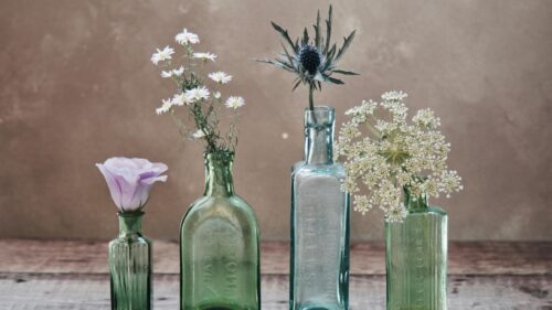 Vintage Glass Bottles with Delicate Flowers Desktop Wallpaper