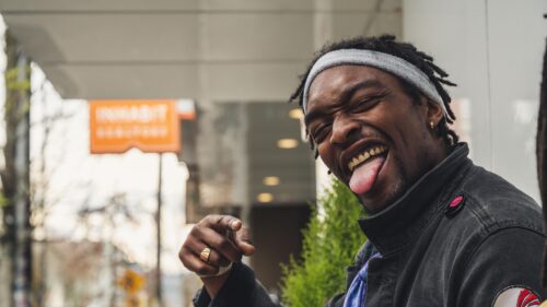 Funny Man Smiling with Tongue Out Street Portrait 4K Desktop Wallpaper