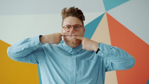 Funny Man Making Silly Face Against Colorful Geometric Background 4K Wallpaper