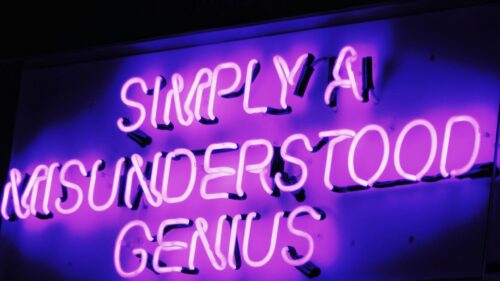 Simply A Misunderstood Genius Purple Neon Sign 4K Desktop Wallpaper