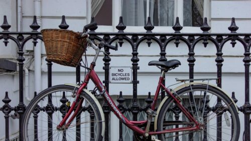 Ironic Red Bicycle Parked Against No Bicycles Sign Desktop Wallpaper