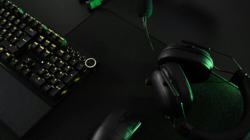 Gamer Desk Setup with Green RGB Keyboard and Headset 4K Wallpaper
