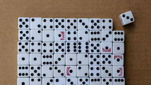 Macro Shot of White Dice Arranged on Textured Brown Background 4K Wallpaper