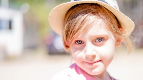 Adorable Young Girl in Straw Hat Sunlight Portrait 4K Wallpaper