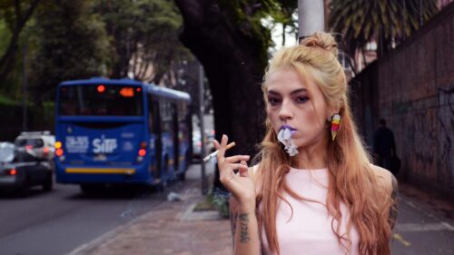 Edgy Blonde Girl Smoking on City Street 4K Desktop Wallpaper