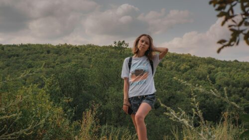 Young Woman Hiking in Forested Hills Desktop Wallpaper