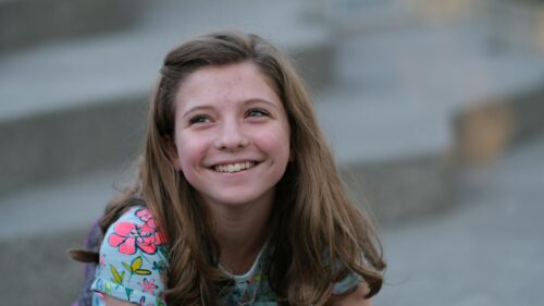 Happy Smiling Young Girl Looking Up Cinematic 4K Wallpaper