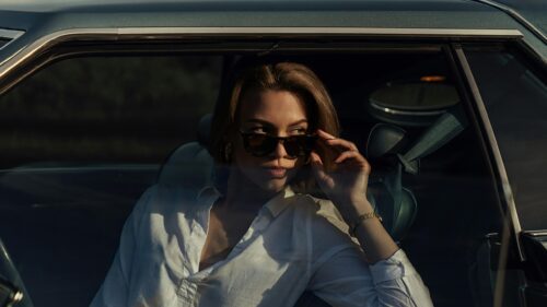 Chic Woman in Sunglasses Sitting in Vintage Car 4K Wallpaper
