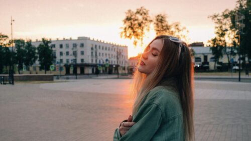 Dreamy Girl Enjoying Golden Hour Sunset Desktop Wallpaper