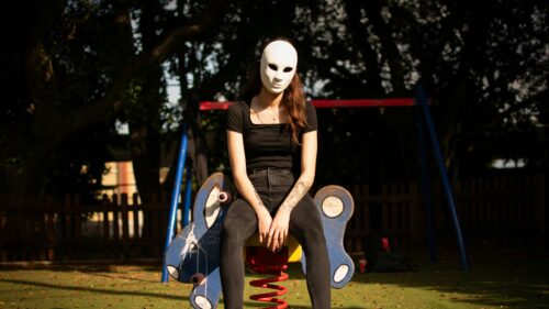 Mysterious Girl Wearing a Blank White Face Mask Desktop Wallpaper