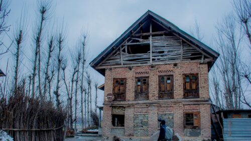 Dilapidated Brick House in Winter Landscape 4K Wallpaper