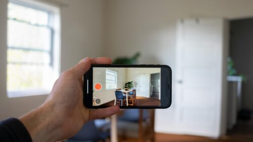 Hand Holding Phone Recording Modern Dining Room Interior 4K Wallpaper
