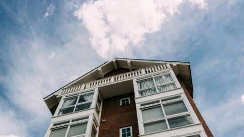 Low Angle View of Red Brick Modern House Against Blue Sky 4K Wallpaper