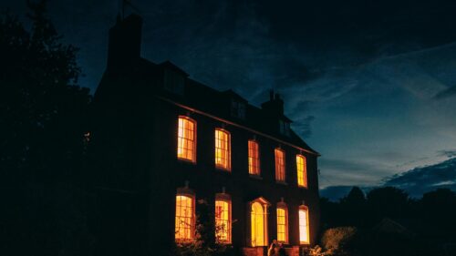 Mysterious Dark Manor with Warm Golden Windows 4K Desktop Wallpaper